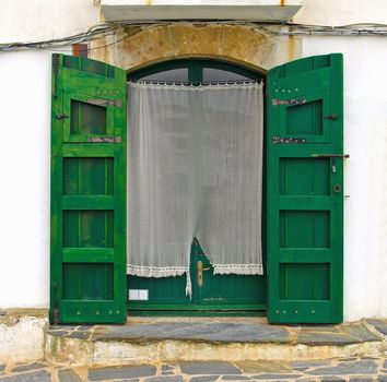 Old green door with shutters, Cadaques village, Costa Brava, Spain