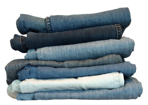 Stack of blue and black jeans over white with clipping path