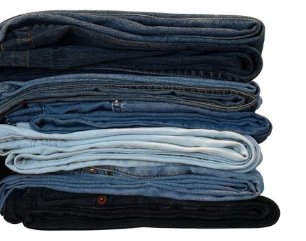 Stack of blue and black jeans over white with clipping path