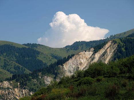 Mountains with landslide on blue sky. Tien Shan. Kazakhstan.