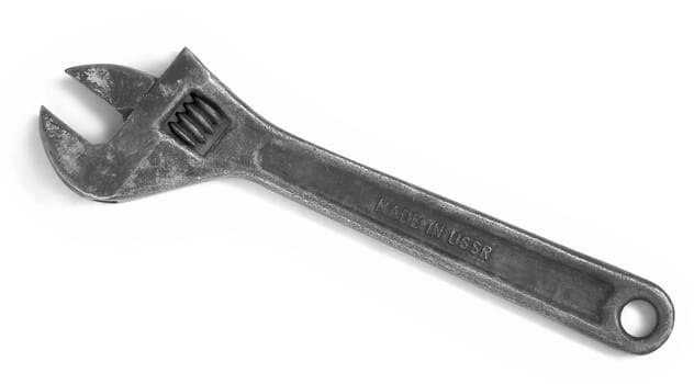 Old adjustable spanner isolated over white. Made in USSR.