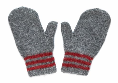 Grey mittens with red stripe on wrist over white background