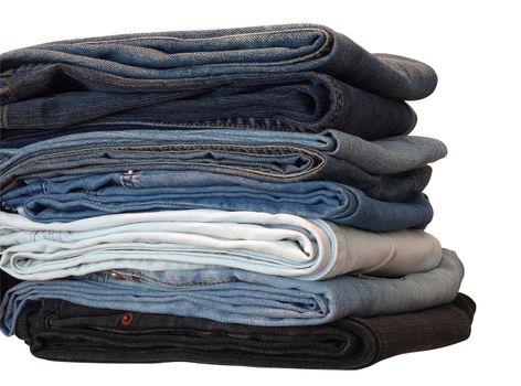 Stack of blue and black jeans over white with clipping path