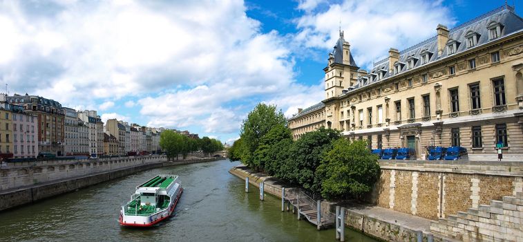 River seine with water bus and famous quay des Orfe`vres in Paris where the judicial police