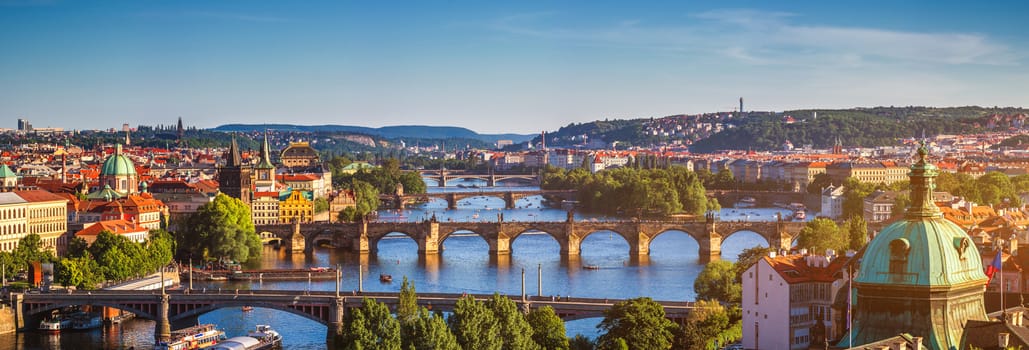 Scenic spring sunset aerial view of the Old Town pier architecture and Charles Bridge over Vltava river in Prague, Czech Republic