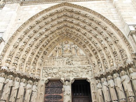 Notre Dame Cathedral in Paris showing door detail with scenes from the Bible
