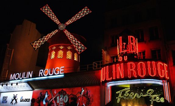 PARIS FRANCE - JULY 24: The Moulin Rouge by night July 24, 2009 in Paris, France. Moulin Rouge is a famous cabaret built in 1889, locating in the Paris red-light district of Pigalle