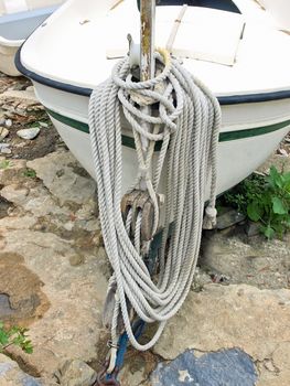 Close-up of rope tied up on a bitt. Village of Cadaques (Costa Brava, Catalonia, Spain)