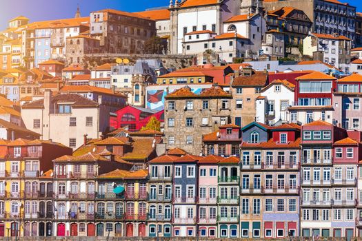 Colorful houses of Porto Ribeira, traditional facades, old multi-colored houses with red roof tiles on the embankment in the city of Porto, Portugal