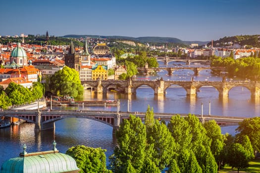 Scenic spring sunset aerial view of the Old Town pier architecture and Charles Bridge over Vltava river in Prague, Czech Republic