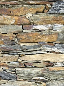 Texture of stone wall of a medieval building in warm sunlight - saint-tropez, French Rivera