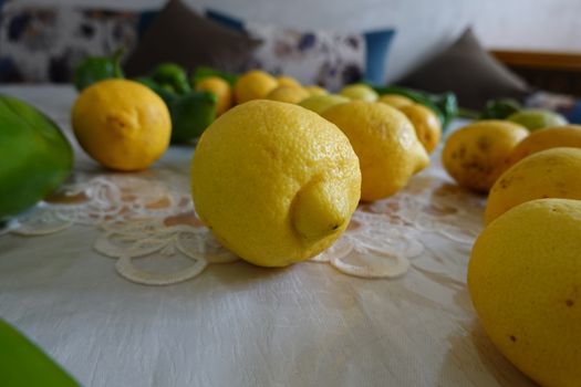 yellow fresh lemons and green peper on a table.