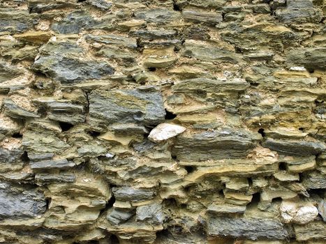 Texture of stone wall of a medieval building in warm sunlight - saint-tropez, French Rivera