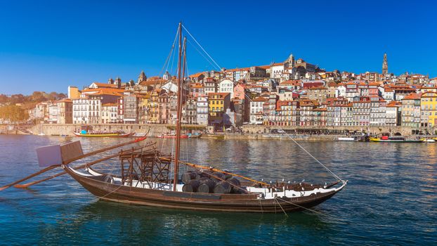Oporto or Porto city skyline, Douro river, traditional boats and Dom Luis or Luiz iron bridge. Porto, Portugal, Europe.