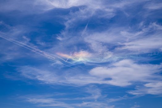 Circumzenithal arc against blue sky with white clouds seen in south of France near Marseille during summer 2019 (31st July 2019)