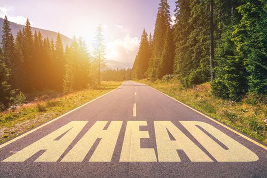 Ahead word written on road in the mountains