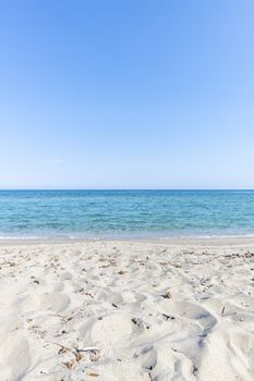 Sandy Beach and mediterranean sea during summer with large copy space, Ghisonaccia, Corsica, France (looking to the horizon)