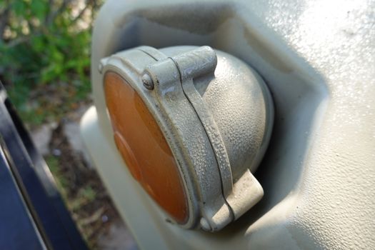 an old military green truck front light. 