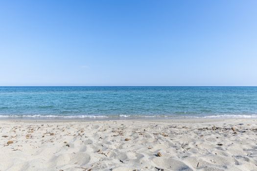 Sandy Beach and mediterranean sea during summer with large copy space, Ghisonaccia, Corsica, France (looking to the horizon)
