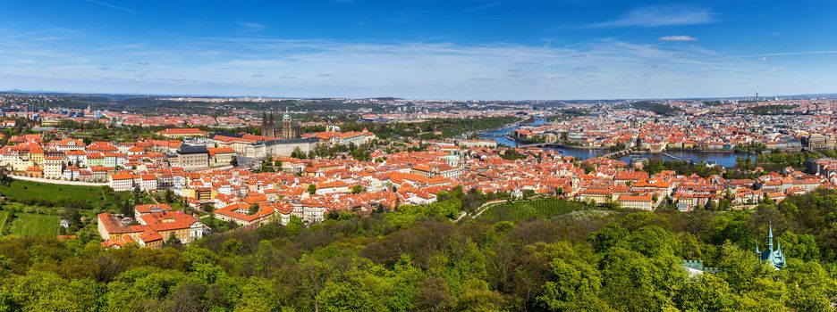 Aerial view of old Red Tiles roofs in the city Prague, Czech Republic, Europe. Beautiful day with blue sky with clouds in the town.