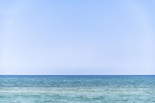 mediterranean sea during summer with large copy space in the light blue sky, Ghisonaccia, Corsica, France (looking to the horizon)