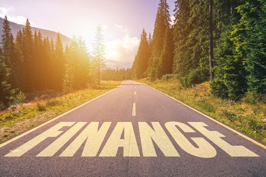 Finance word written on road in the mountains