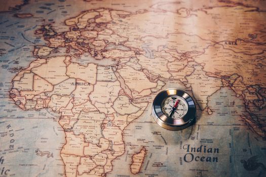 Travel concept background, vintage compas and old earth map 
