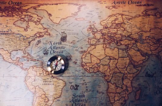 Old compass on vintage map. Adventure stories background. Retro style. The map used for background is in Public domain. Map source: Library of Congress. Country: Belgium Year: 1570. Author: Abraham Ortelius (1527-1598)