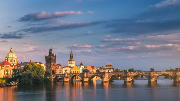 Prague, Czech Republic panorama with historic Charles Bridge and Vltava river on sunny day.