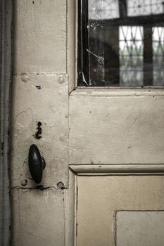 Details and particulars of an old door painted white.