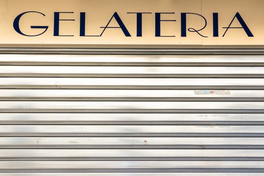 An old Italian ice cream shop with the lowered shutter.