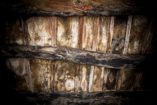 Old wood ceiling with beams on timber background