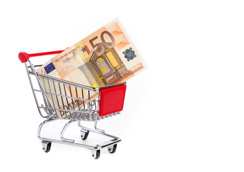 Consuming concept with shopping cart and 50 euro bill inside