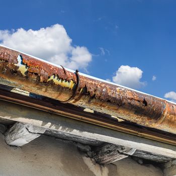 Broken gutter on the roof of a house