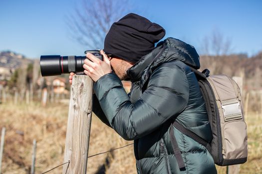 Nature photographer in action with macro lens.