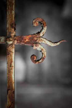 Details of a white fence which has become rusted through years of neglect.