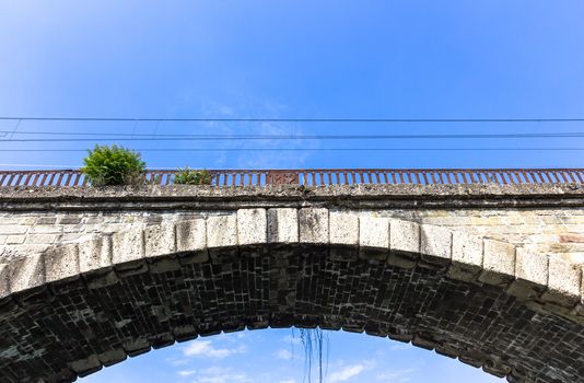 Old railroad bridge with stone arch