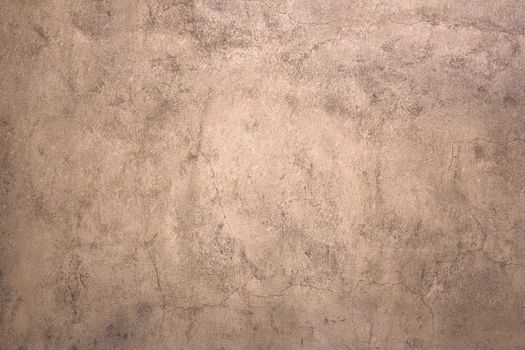 An old wall finished with stucco with brown tones.