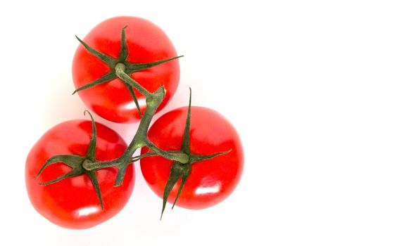 Three ripe tomatoes viewed from above and isolated on white background.