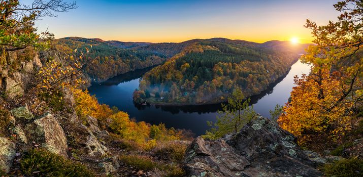River canyon with dark water and autumn colorful forest. Horseshoe bend, Vltava river, Czech republic. Beautiful landscape with river