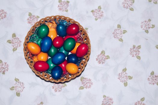 Close up of colorful Easter eggs in a basket. Happy Easter, Christian religious holiday.