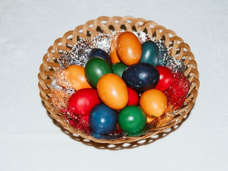 Colorful easter eggs in basket. Happy Easter, Christian religious holiday.