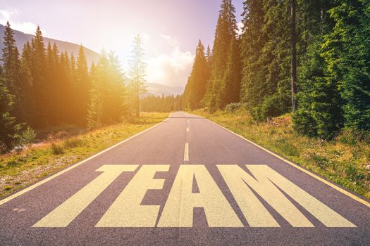 Team word written on road in the mountains