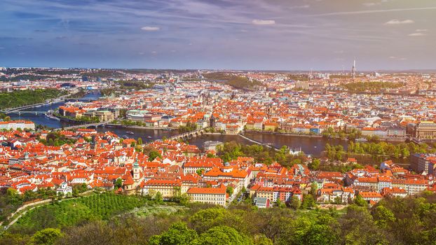 erial view of old Red Tiles roofs in the city Prague, Czech Republic, Europe. Beautiful day with blue sky with clouds in the town.