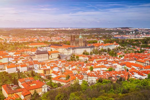erial view of old Red Tiles roofs in the city Prague, Czech Republic, Europe. Beautiful day with blue sky with clouds in the town.