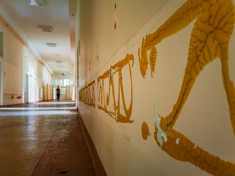 Old glue on wall of corridor in old abandoned hospital