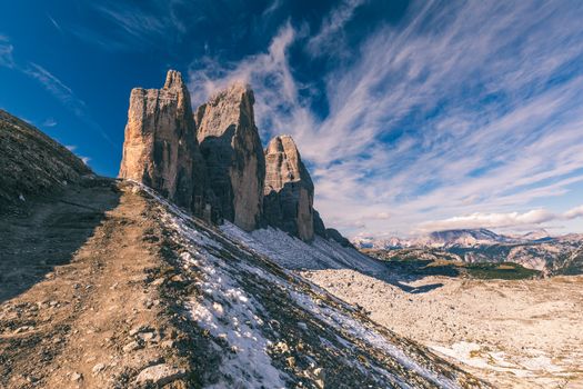 Hiking Trail in Tre Cime di Laveredo. Lake. Meadow. Green Grass. Summer. Blue Sky. Mountain Peak. Dolomites. Italy. Tre cime are one of the best-known mountain groups in the European Alps