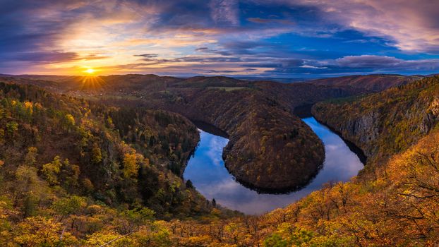 Panoramic view of river canyon with dark water and autumn colorful forest. Horseshoe bend, Vltava river, Czech republic. Beautiful landscape with river. Maj lookout.