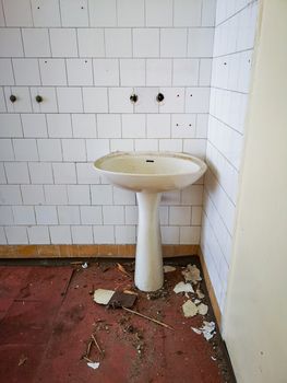Old sink against the wall in old abandoned hospital