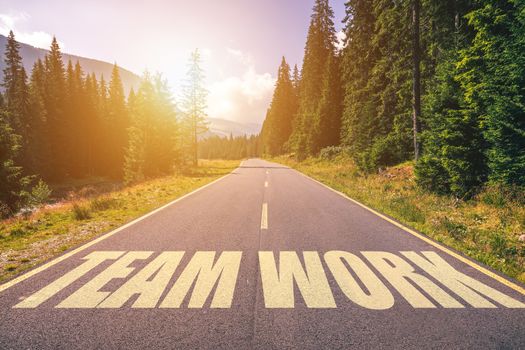 Team Work words written on road in the mountains